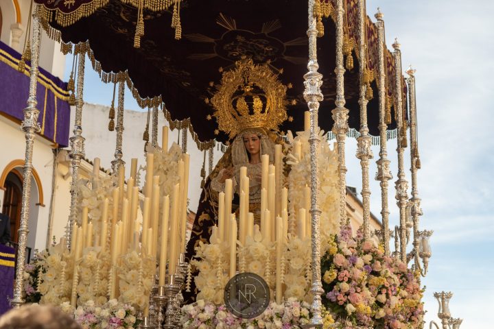 María Santísima de las Lágrimas bajo palio, entre cera y flores